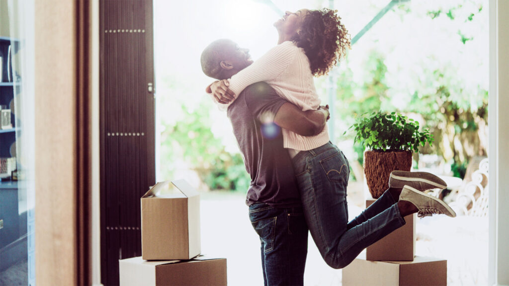 couple moving into their new home surrounded by boxes